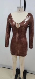 Detail of sequin bodycon dress featuring a deep V-neck and lace-up front design