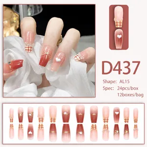 Pink gradient press-on nails set with pearl accents, heart 3D charms, and white grid patterns