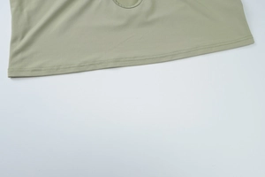 Detailed view of sage green knitted crop top hem showing professional double stitching