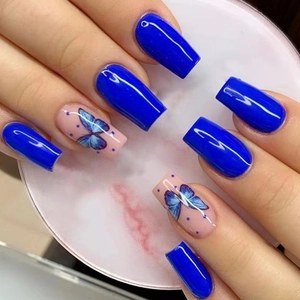 Long ballerina press-on nails in Klein blue with elegant butterfly and dot art patterns