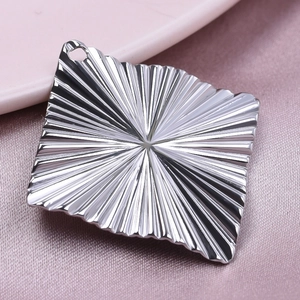Macro shot of silver diamond pendant with radial texture for DIY jewelry making