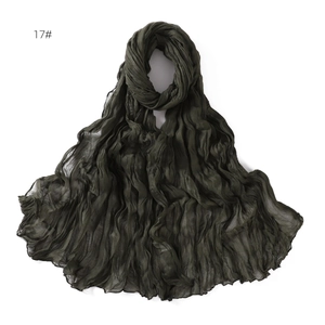Detail shot of lightweight dark green crinkle scarf with soft breathable texture