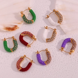 Detail view of U-shaped gold-plated earrings with colorful zircon and enamel drip accents