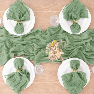 Sage green cheesecloth table runner set with four matching napkins and gold rings