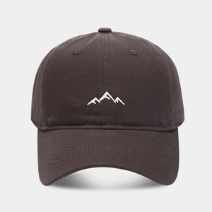 Close-up of white mountain range embroidery on a dark charcoal cotton baseball cap