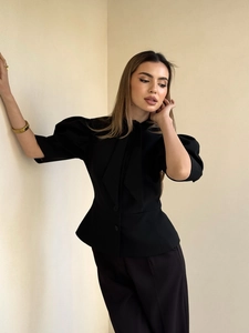 Detail view of Hepburn style puff sleeve top with waist tie design in black color
