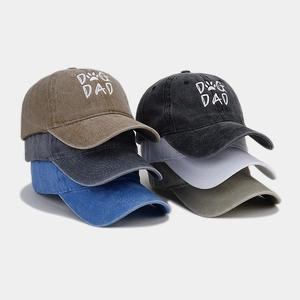 Detail of multi-color washed cotton baseball caps with Dog Dad embroidery and metal buckles