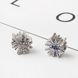 Silver snowflake earrings with sparkling blue and white crystals on a card