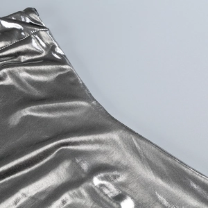 Detailed view of silver metallic fabric texture and fine stitching on a slim dress