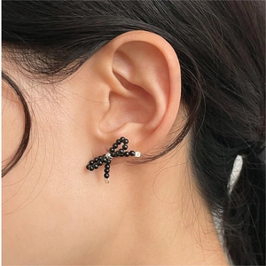 Elegant 925 sterling silver bow earrings with black beads for a minimalist style