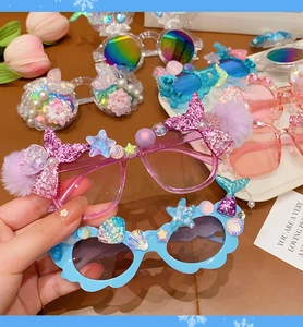 Detail of mermaid themed sunglasses for girls featuring pearls and shell decorations