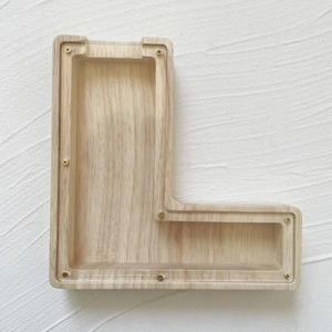 Detailed view of the L-shaped oak wood money box with transparent acrylic panel and screws