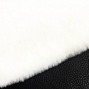 Detail of white faux rabbit fur and black lychee texture leather on Christmas tree skirt