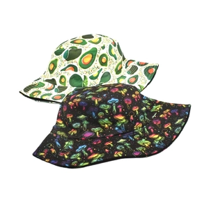 Detail of reversible bucket hats with avocado print and colorful mushroom patterns