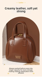 Macro shot of large brown leather cosmetic bag with gold zippers and spacious interior