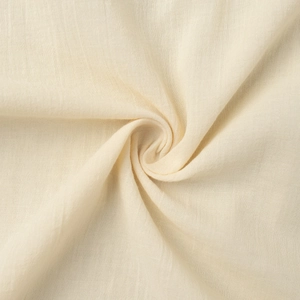 Close-up of beige cotton linen fabric showing natural texture and breathable weave
