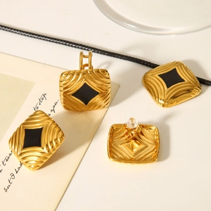 Detail of 18K gold stainless steel square earrings with wave texture and black enamel