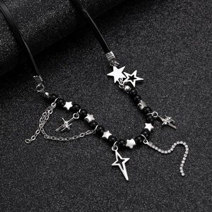 Macro detail of gothic beaded necklace with silver star charms and sparkling rhinestones