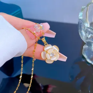 Detailed view of camellia flower necklace pendant with cat-eye petals and gold chain