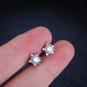 Macro detail of S925 sterling silver star stud earrings with brilliant moissanite stones