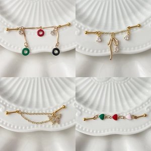 Golden industrial piercing barbells with colorful butterfly, heart and crystal charms