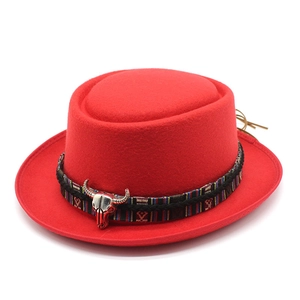 Detail of red wool pork pie hat with ethnic woven band and silver bull skull accent