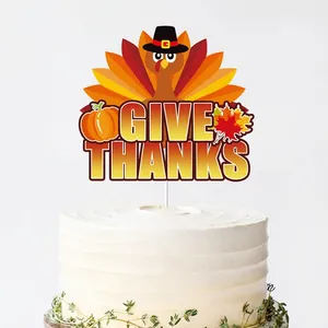 Thanksgiving cake topper set with turkey and maple leaves on a white cream cake