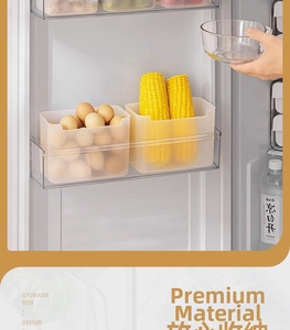 Detailed view of clear plastic storage boxes for organizing eggs and vegetables in the fridge