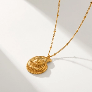 Minimalist 18k gold stainless steel necklace featuring a textured conch shell pendant