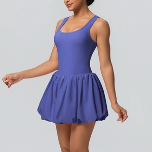 Close-up of a purple sleeveless tennis dress with a pleated hem and slim fit waist