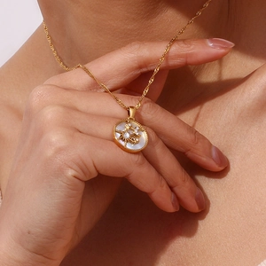 Detail of 18K gold plated celestial pendant with mother of pearl and star zircon inlay