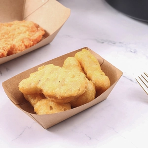 Eco-friendly kraft paper food tray filled with fried chicken on a marble surface