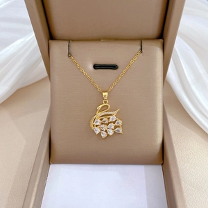 Luxurious gold swan pendant necklace with sparkling white crystals in a gift box