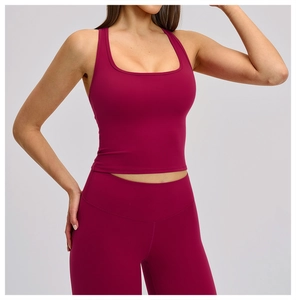 Front view of tight-fitting burgundy sports crop top and high-waisted yoga leggings