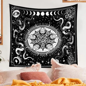 Detail of black tarot tapestry with white star and moon patterns on a bedroom wall