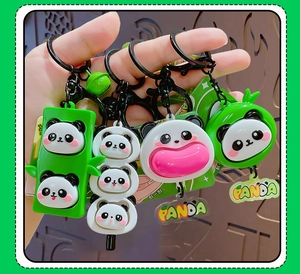 Detail of four panda squeeze pendants with bamboo and mochi designs on black keyrings