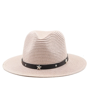Detail of light pink straw cowboy hat featuring black leather band with silver star studs