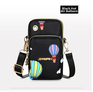 Detailed view of black nylon phone bag with colorful hot air balloon print and earphone port