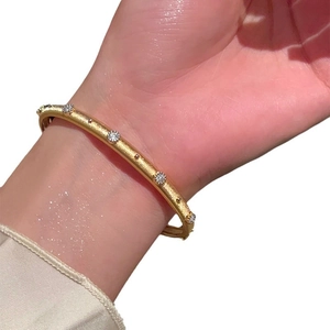 Elegant gold plated brushed bangle with sparkling zircon stones in a vintage French style