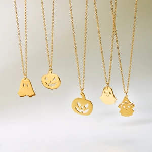Golden stainless steel Halloween necklaces featuring ghost and pumpkin pendants on chains