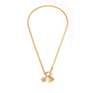 Detailed view of gold snake chain with shell, flower, and coffee bean pendants