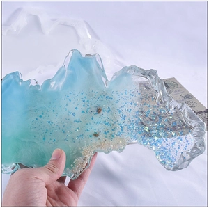 Close-up of irregular ocean wave resin tray featuring blue gradients and sand textures