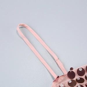 Detail of pink sequin evening dress showing adjustable straps and mesh texture