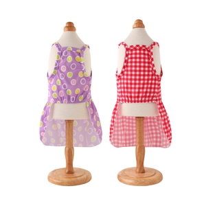 Polka dot and checkered pet dresses for cats and dogs on white display stands