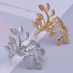 Macro view of minimalist 304 stainless steel leaf rings in polished gold and silver finishes
