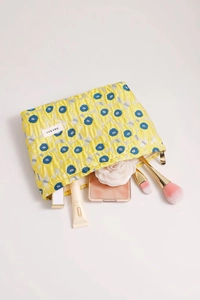 Detail of floral jacquard makeup bag showing interior storage capacity and metal zipper
