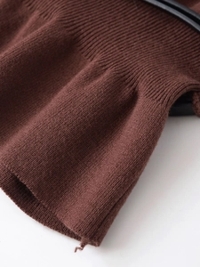 Detailed macro view of dark brown knit fabric showing rib texture and smooth finish