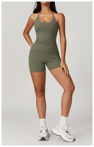Full body view of a dark green halter neck yoga jumpsuit with high waist slim fit design
