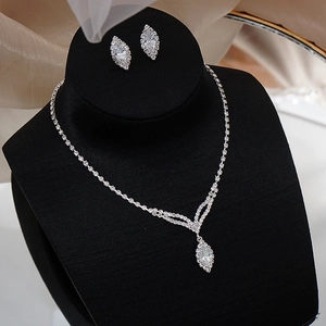 Detail view of silver bridal jewelry set with marquise-cut crystals on a display