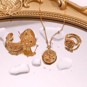 Close-up of vintage celestial jewelry set with moon star motifs on mirror surface